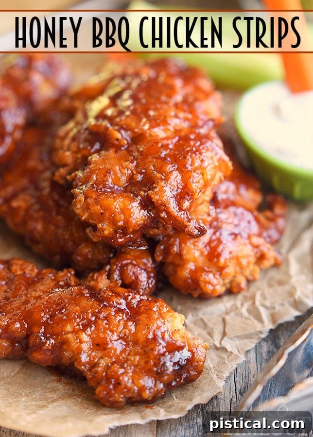 Freshly glazed Honey BBQ Chicken Strips emerging from the oven, glistening with a rich, caramelized sauce.