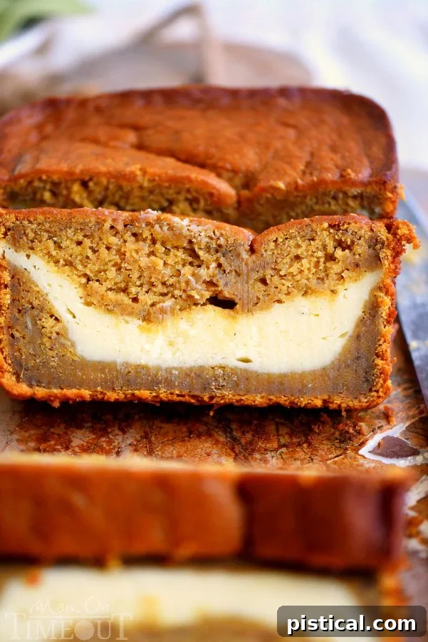 Perfectly baked Pumpkin Cheesecake Banana Bread: a harmonious blend of pumpkin, banana, and a creamy cheesecake ribbon. Ideal for any occasion. Two generous slices of pumpkin cheesecake banana bread, showcasing the vibrant pumpkin hue and creamy white cheesecake swirl, inviting a delightful bite.