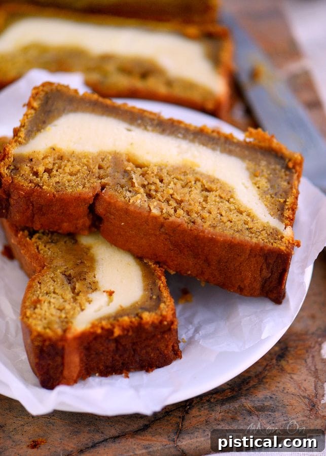 Golden brown and perfectly baked Pumpkin Cheesecake Banana Bread cooling on a wire rack. A top-down view of a cooling loaf of Pumpkin Cheesecake Banana Bread, showing the golden-brown crust and inviting texture.