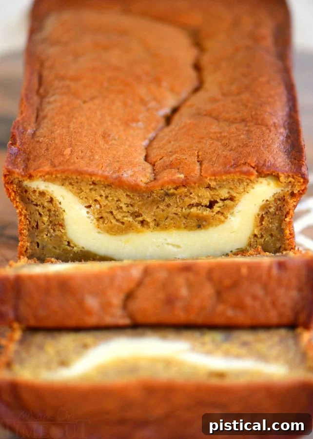 Detailed view of a slice of Pumpkin Cheesecake Banana Bread, showing its delectable moistness and rich flavor layers. A close-up of a generously thick slice of Pumpkin Cheesecake Banana Bread, highlighting the creamy cheesecake layer and moist crumb texture.