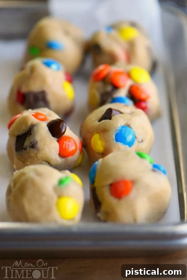 Freshly baked M&M and chocolate chunk cookies on a cooling rack, showcasing their perfect texture.