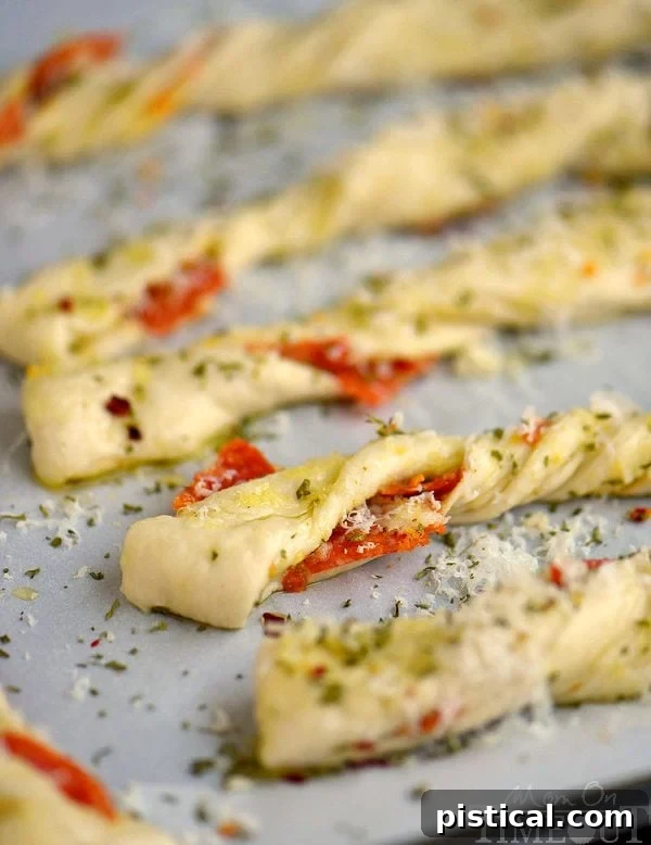 Perfect for game day celebrations or a fun, kid-friendly dinner, these Pepperoni Pizza Twists are guaranteed to become a new family favorite! Easy, cheesy, awesomeness!