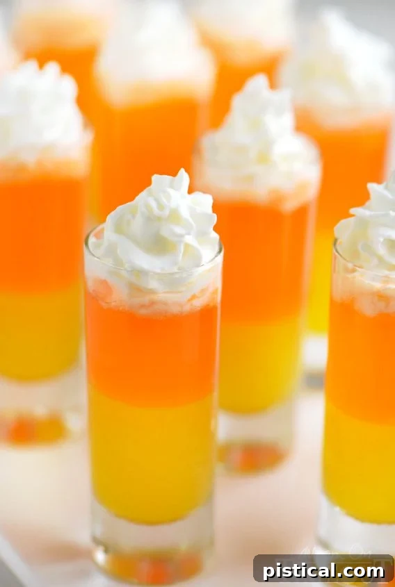 Candy Corn Nibbles 6 A refreshing Candy Corn Popper drink with its signature layers of yellow, orange, and white, ready for a festive celebration.