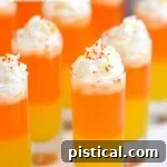 Candy Corn Nibbles 7 Thumbnail image of a Candy Corn Popper, a layered non-alcoholic drink for kids.