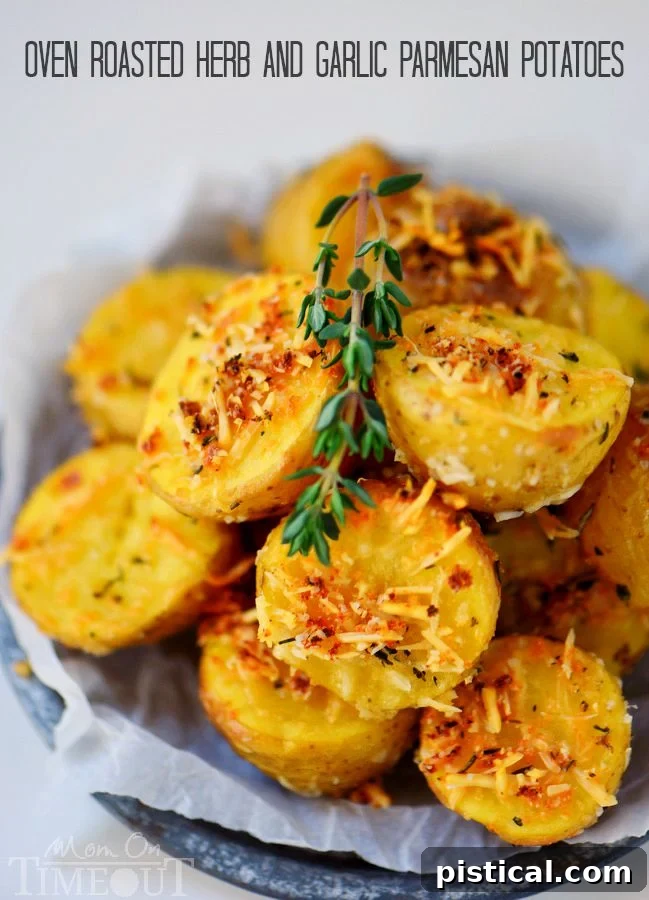 Vibrant close-up of Oven Roasted Herb and Garlic Parmesan Potatoes freshly out of the oven, sprinkled with extra fresh herbs and Parmesan, ready for serving.