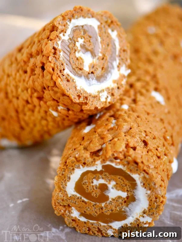 A close-up of a sliced Caramel Pumpkin Spice Rice Krispies Treats Pinwheel, revealing its beautiful spiral layers of flavor.