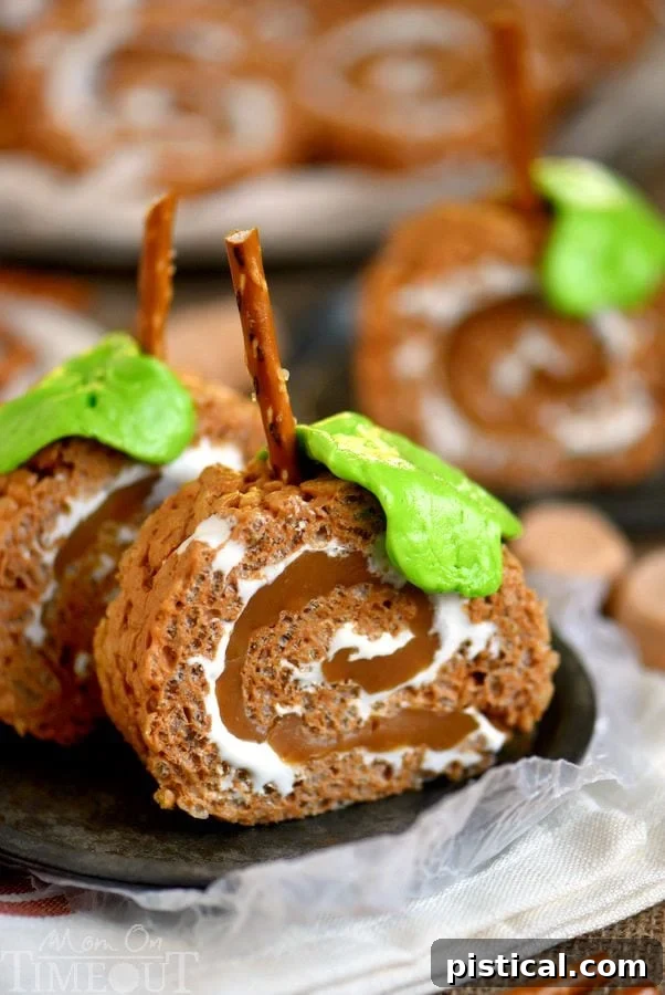 Beautifully decorated Caramel Pumpkin Spice Rice Krispies Treats Pinwheels resembling mini pumpkins, complete with pretzel stems and Laffy Taffy leaves.