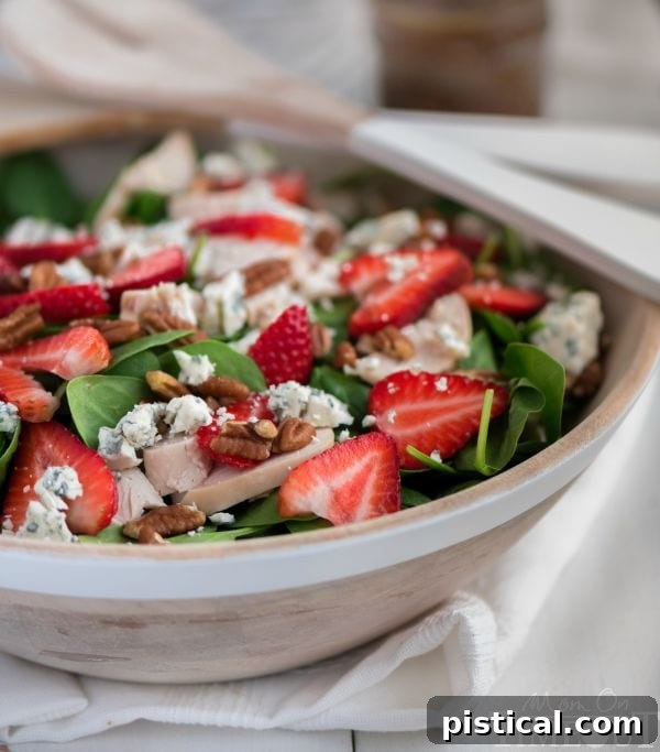 Fresh strawberry spinach salad with chicken, representing healthy and quick meal options