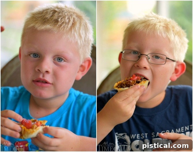 Two happy children enthusiastically eating Cheesy Beef and Black Bean Enchilada Boats with their hands