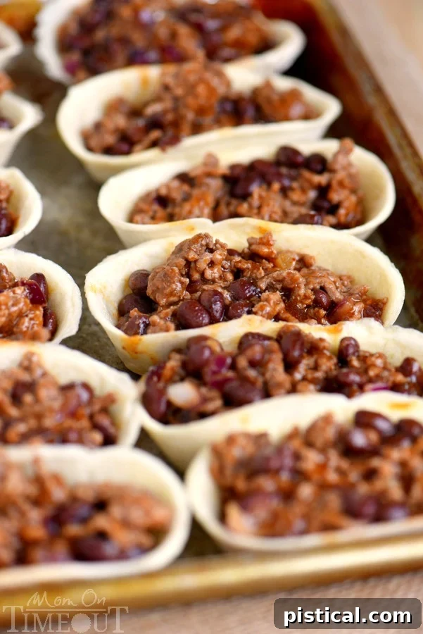 Old El Paso Mini Taco Boats filled with the cheesy beef and black bean mixture, ready for baking