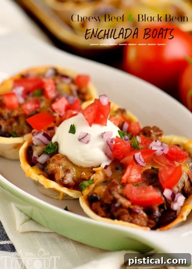 Beautifully baked Cheesy Beef and Black Bean Enchilada Boats, topped with sour cream and fresh herbs