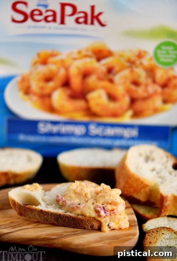 Fire-Roasted Red Pepper Shrimp Scampi Dip 5 Roasted Red Pepper Shrimp Scampi Dip being scooped, showing the melted cheese and tender shrimp.