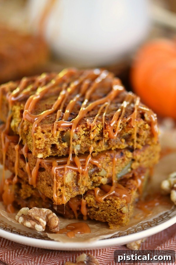 Up close view of golden Caramel Pumpkin Blondies, studded with walnuts and swirled with a luscious caramel topping.