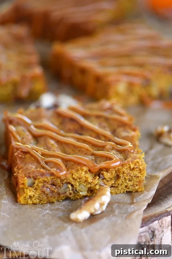 A tray of freshly baked Caramel Pumpkin Blondies, ready to be cut into squares and served, showcasing their perfect texture and golden-brown top.