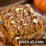 Close-up of a single Caramel Pumpkin Blondie, showing its moist texture, walnuts, and caramel drizzle.