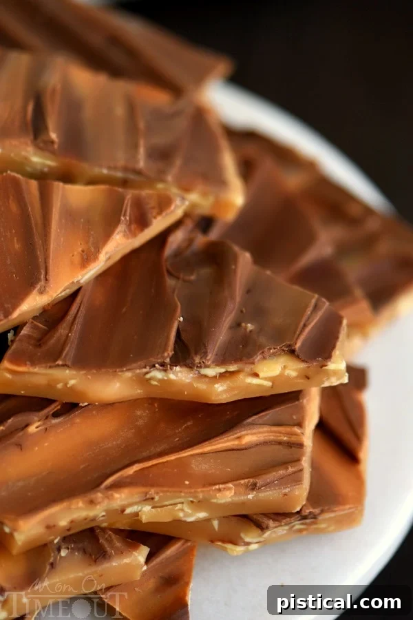Swirled butterscotch and milk chocolate topping on easy homemade almond toffee, creating an elegant pattern