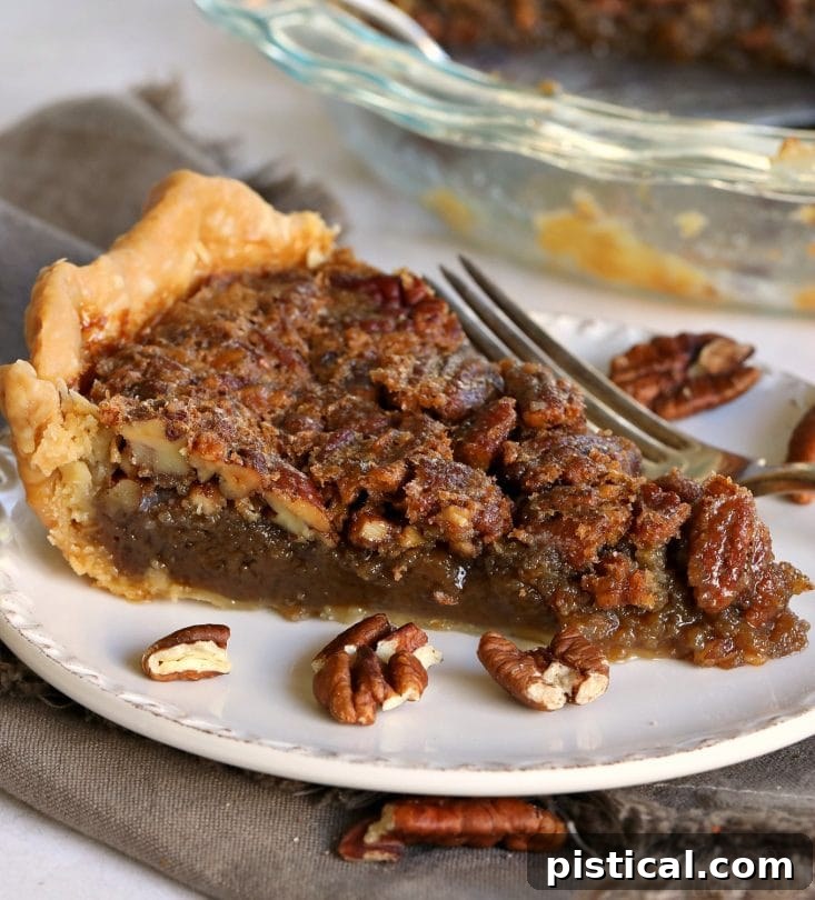 Close-up of a slice of brown sugar pecan pie showing the rich, gooey filling and toasted pecans