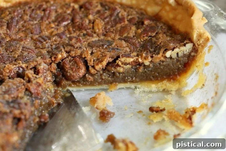 Baked brown sugar pecan pie in a decorative pie plate, showcasing its golden crust and rich filling