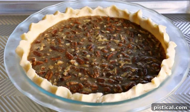 Brown sugar pecan pie on a baking sheet, freshly baked and cooling