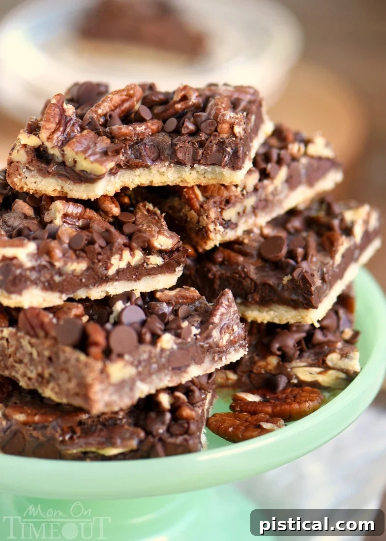 Pecan bars piled high on a vibrant green cake stand, showcasing their rich layers of chocolate and pecans, ready for holiday serving.