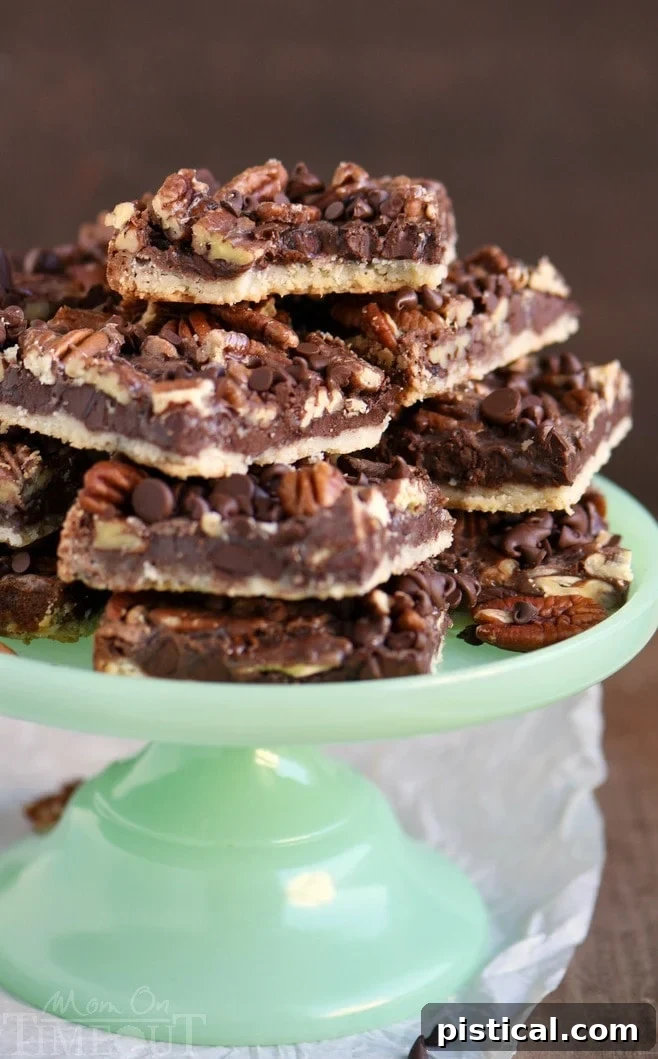 Close-up of a chocolate pecan pie bar with a bite taken out, showing the gooey chocolate and pecan filling and the flaky, golden brown crust.