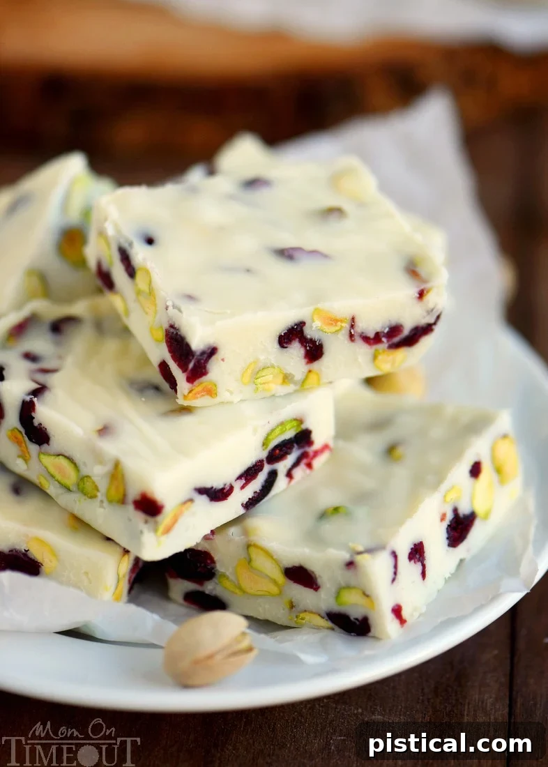 Cranberry Pistachio Fudge recipe - a super quick and easy holiday treat with white chocolate, tart cranberries, and crunchy pistachios. Perfect for gifts or small gatherings.