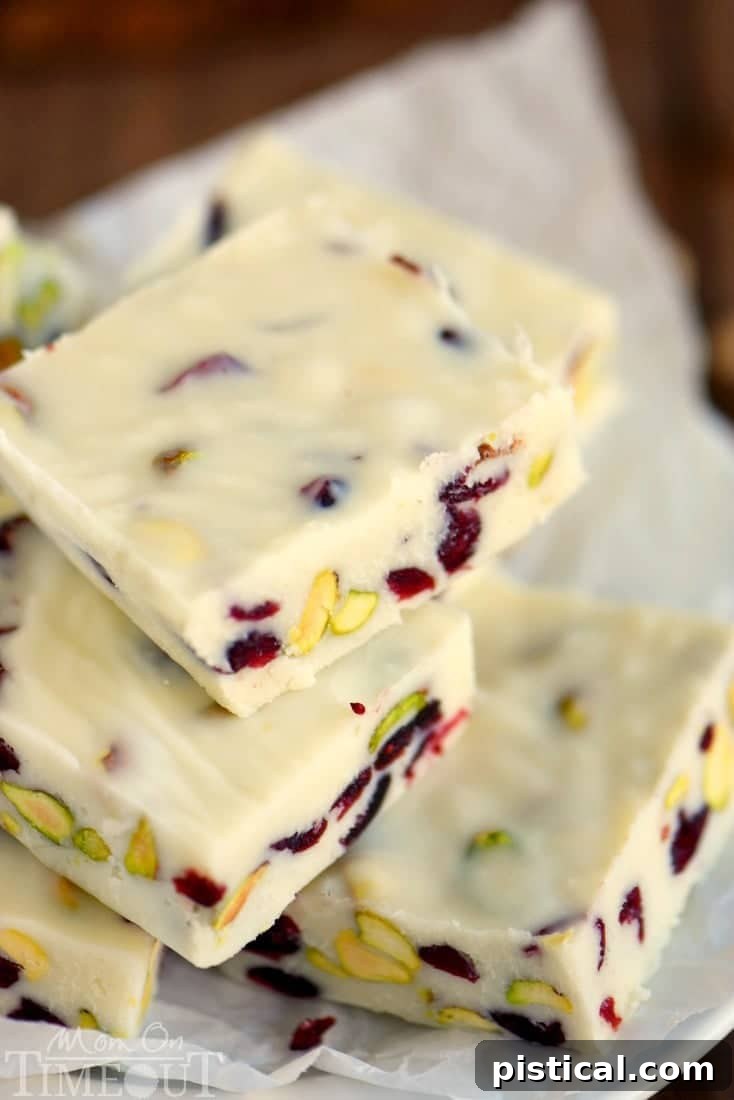 Easy Cranberry Pistachio Fudge setting in a loaf pan, showcasing its festive red and green colors. A super quick holiday dessert ready in minutes.