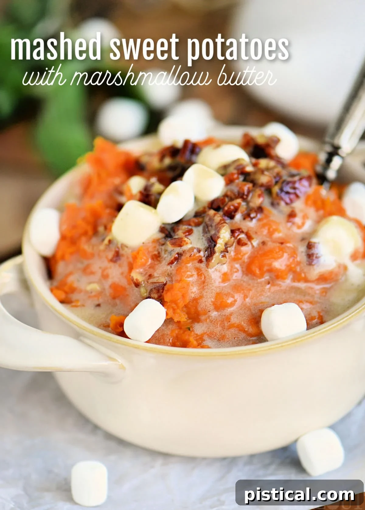 Marshmallow Topped Sweet Potato Bliss 2 Mashed sweet potatoes topped with marshmallows and pecans in a beige bowl