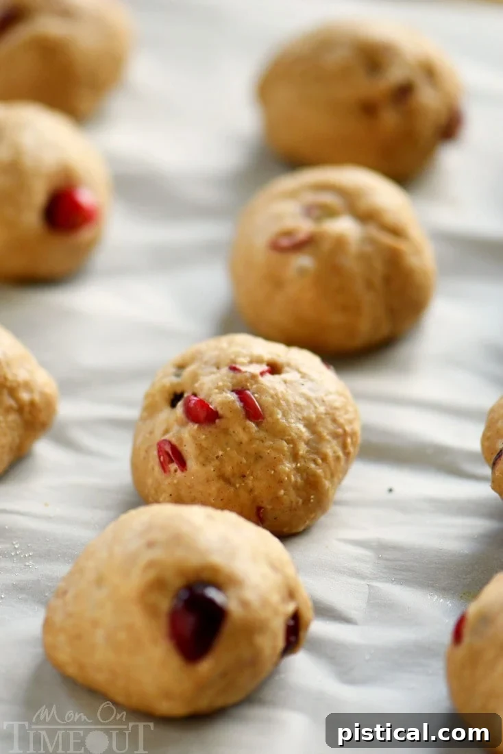 Cranberry yeast rolls for holiday baking, featuring a golden crust and cranberries peeking through.