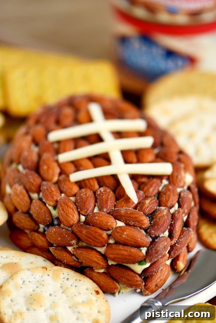Overhead shot of the Cranberry Almond Cheese Ball, highlighting the almond coating and vibrant cranberries, alongside a platter of crackers.