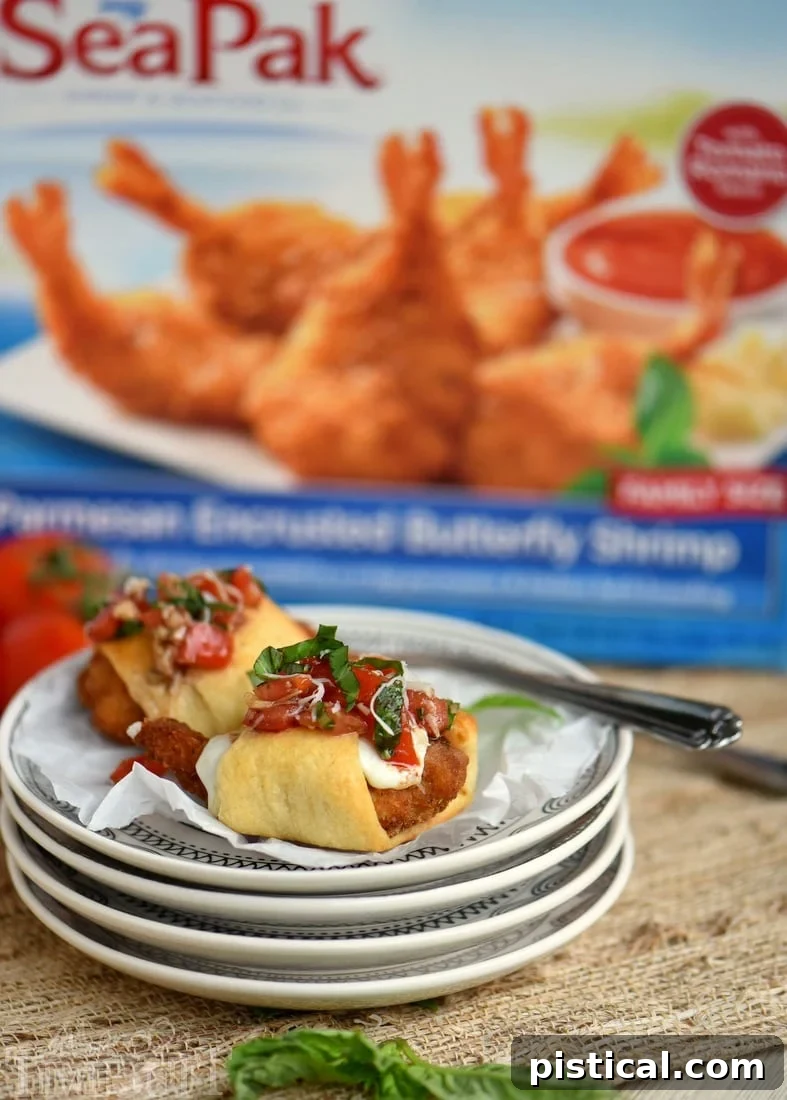 Baked Parmesan Shrimp Bruschetta Bites, golden brown and topped with fresh tomato, basil, and garlic bruschetta.