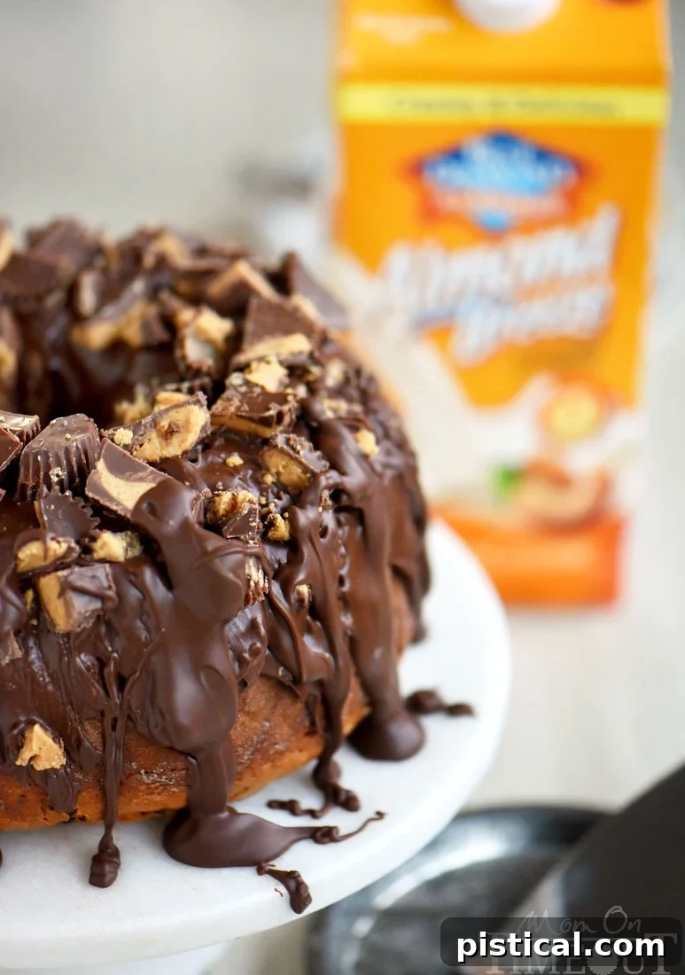 A beautifully baked Reese's Peanut Butter Chocolate Chip Pound Cake, cooling on a wire rack, ready to be glazed.