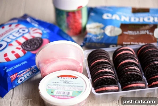Craft irresistible Holiday Dipped Oreos with minimal ingredients and maximum festive flair! Get all my easy how-to instructions and top tips for gourmet results every time. // Mom On Timeout #holidays #christmas #oreos #dippedoreos #candy #cookies #cookietray #dessert #easy Ingredients for holiday dipped Oreos: Peppermint Oreos, melting candy wafers, and various Christmas sprinkles laid out on a table.