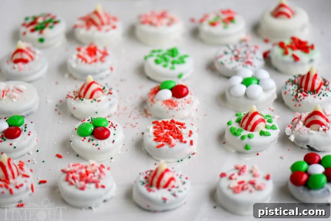 Beautifully decorated Holiday Dipped Oreos on a baking sheet, showcasing the festive results of this easy Christmas treat. Follow my simple how-to guide and tips! A baking sheet filled with a colorful assortment of freshly dipped holiday Oreos, decorated with various sprinkles and candies, cooling on parchment paper.