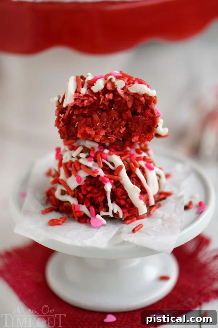 A stunning plate of Red Velvet Coconut Macaroons, glistening with a white drizzle and colorful sprinkles.