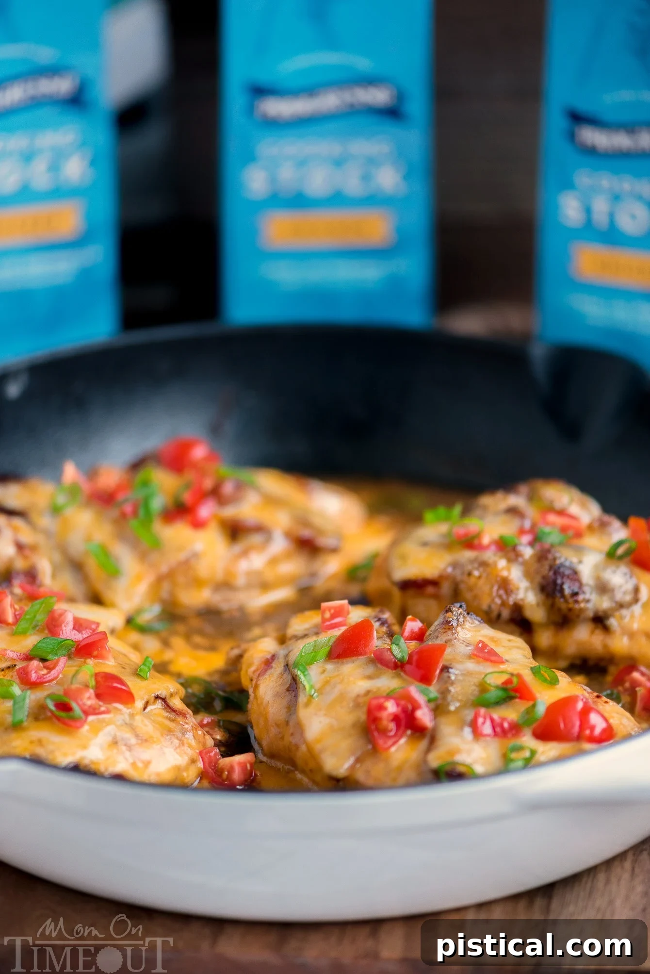 Got 20 minutes? This easy Skillet Monterey Chicken is just what you want to make for dinner tonight...trust me! Chicken, barbecue sauce, bacon, and glorious cheese come together in this delightful yet simple dish. Sure to become a regular request at your home! // Mom On Timeout #montereychicken #chickendinner #skilletdinner #easyrecipe #chicken #bacon #cheese #skillet #recipe Skillet Monterey Chicken served in a white enamel cast iron skillet, showcasing its rustic and appealing presentation.