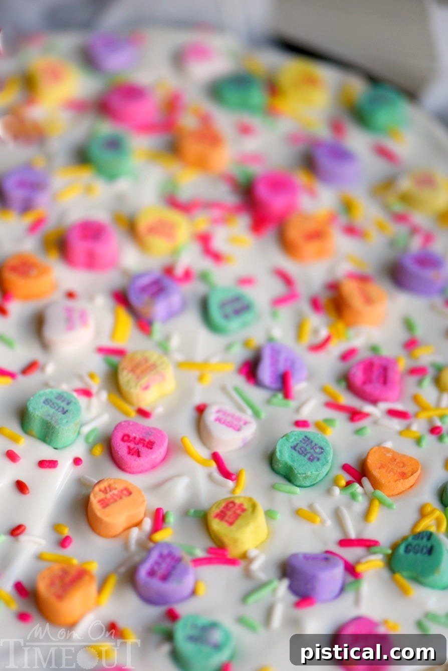 Close-up of Conversation Heart Sugar Cookie Bark with colorful conversation hearts and sprinkles.