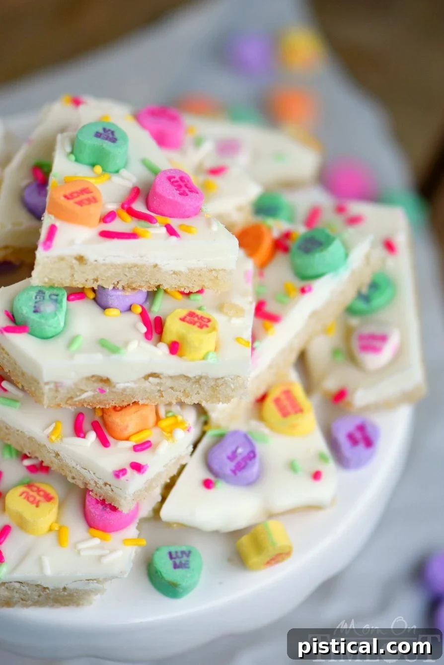 Stack of Conversation Heart Sugar Cookie Bark on a white plate, ready to be served.