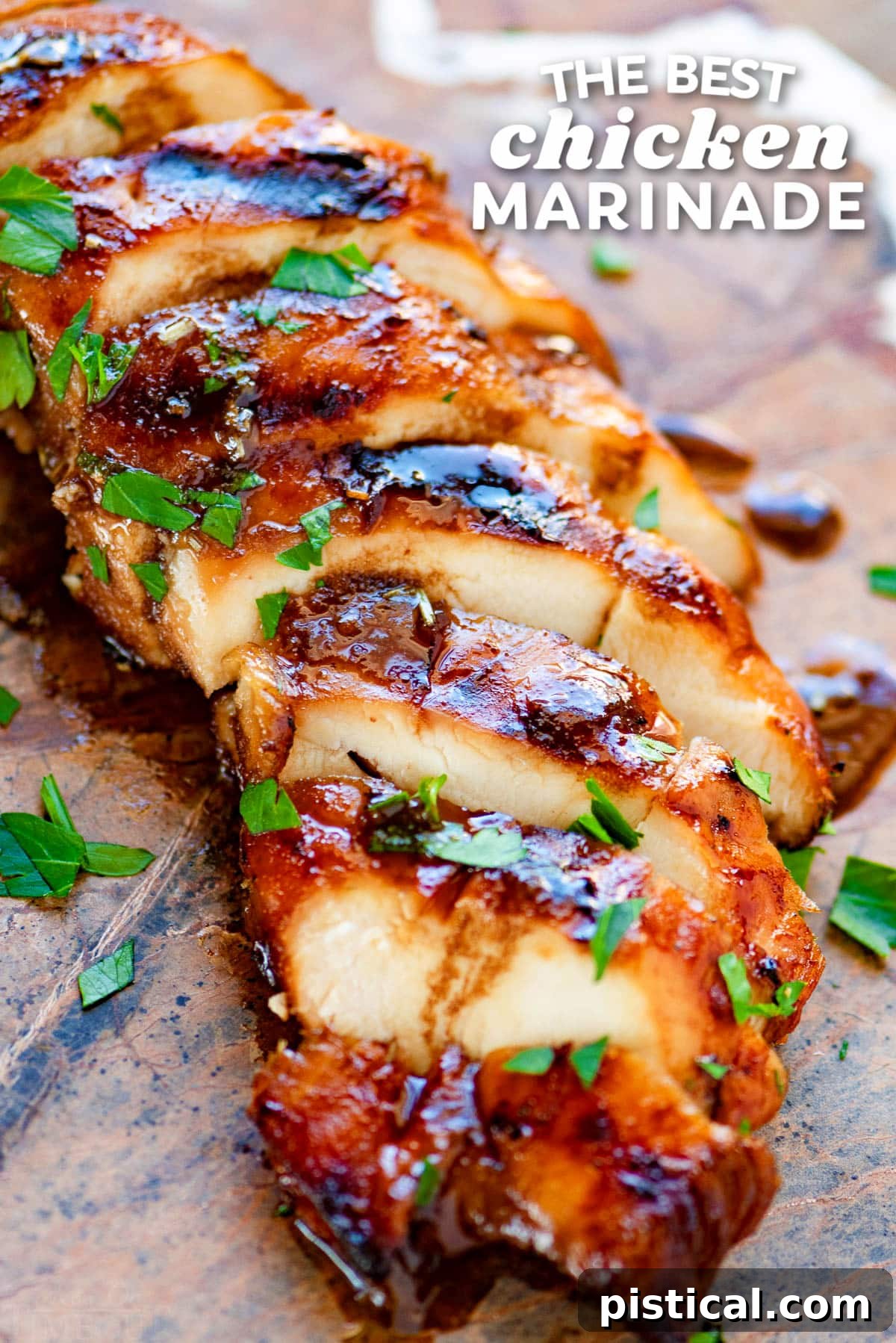 grilled chicken breast made with chicken marinade sliced on stone cutting board with title overlay at top of image.