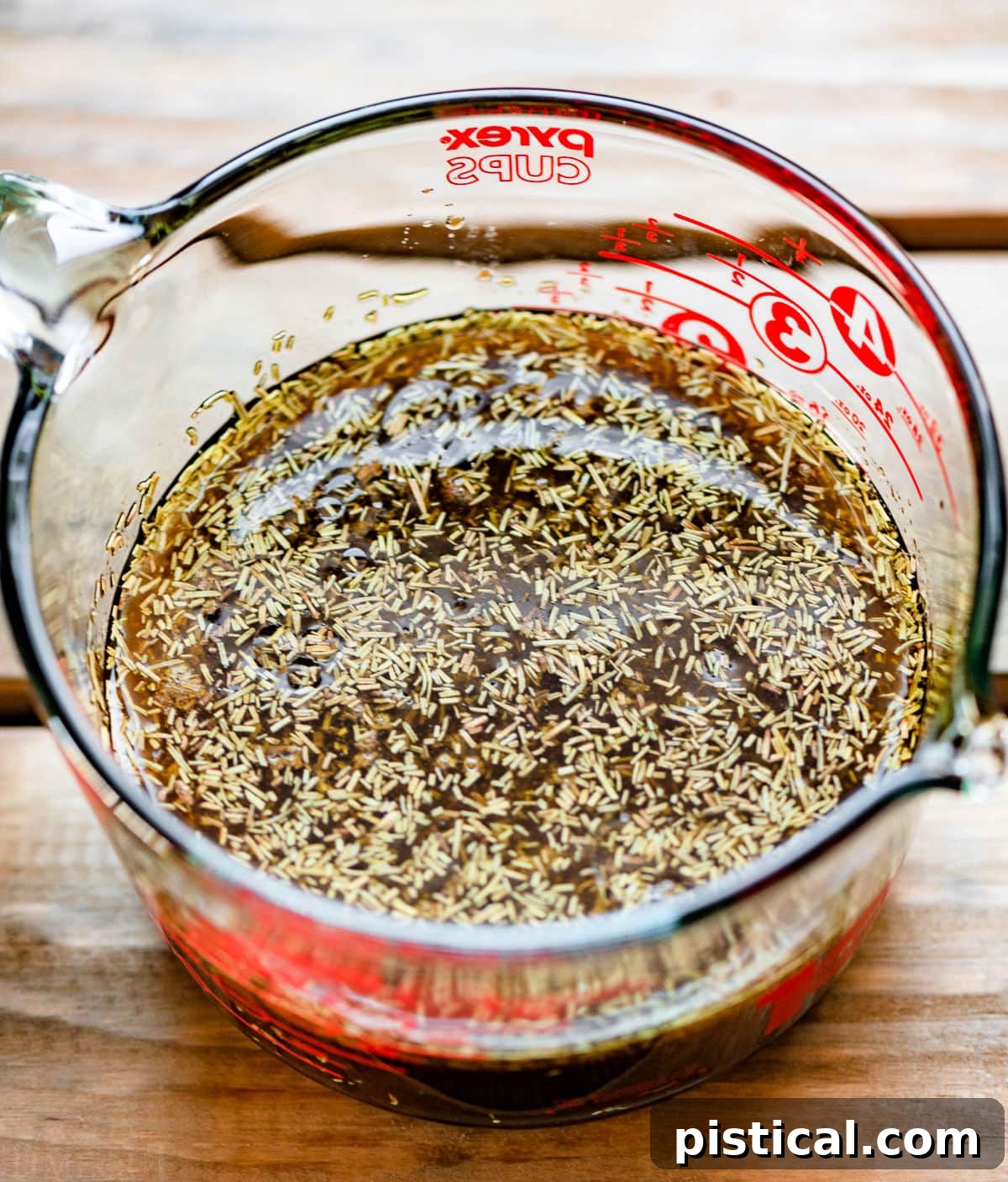 chicken marinade ingredients in a large glass measuring cup.