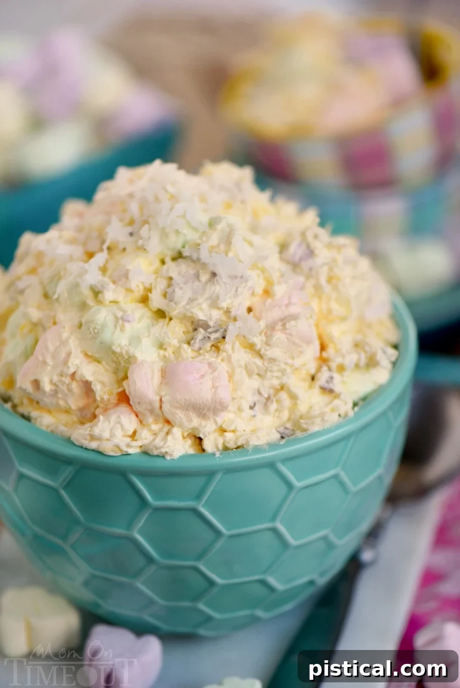Quick Easter Whimsy 3 A serving bowl filled with creamy Easter fluff, featuring mini marshmallows and a hint of pineapple, ready to be enjoyed.