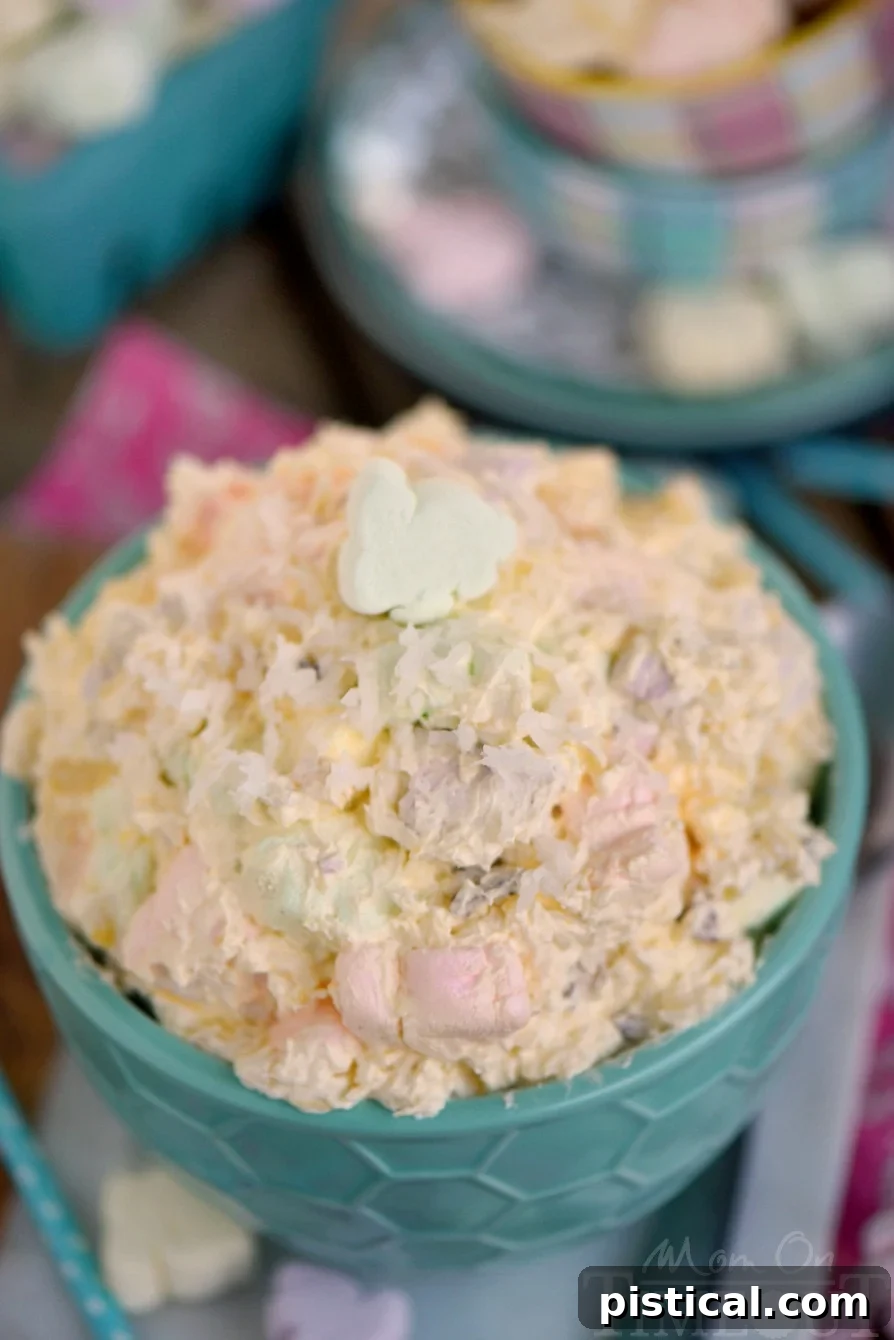 Quick Easter Whimsy 4 A close-up, top-down view of the fluffy Easter dessert in a large green bowl, showcasing its pastel colors and inviting texture.
