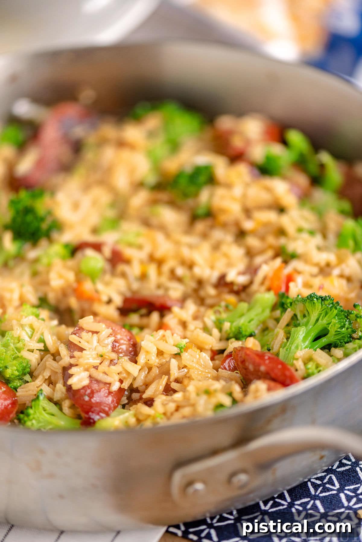 Hearty Cheesy Kielbasa and Broccoli Rice Skillet 4 The finished Cheesy Kielbasa Rice and Broccoli Skillet, hot and ready to eat, served directly from the pan with melted cheese bubbling on top.