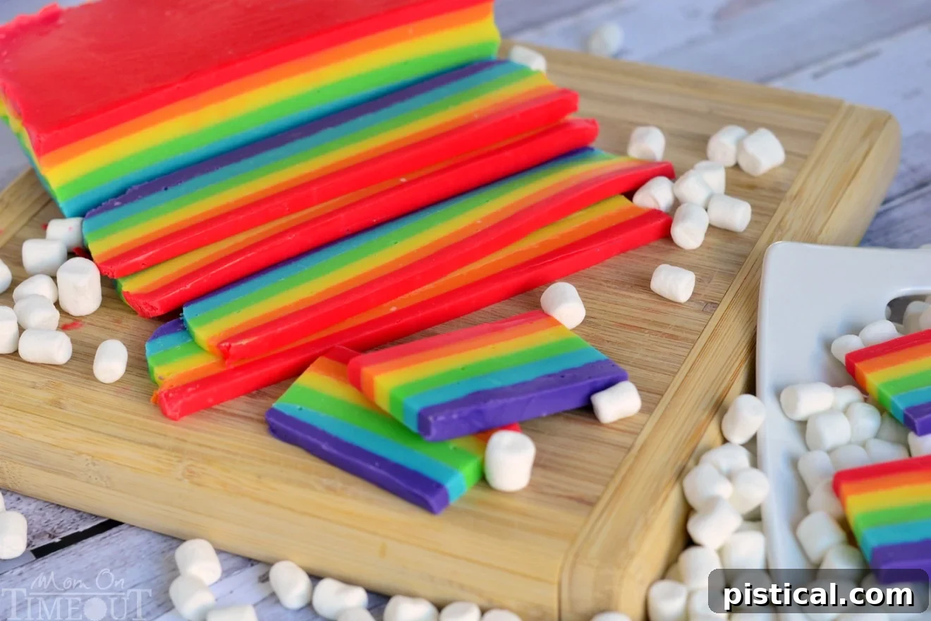 Close-up of the perfectly layered Easy Rainbow Fudge, showcasing vibrant colors and smooth texture, ready to be sliced for guests.