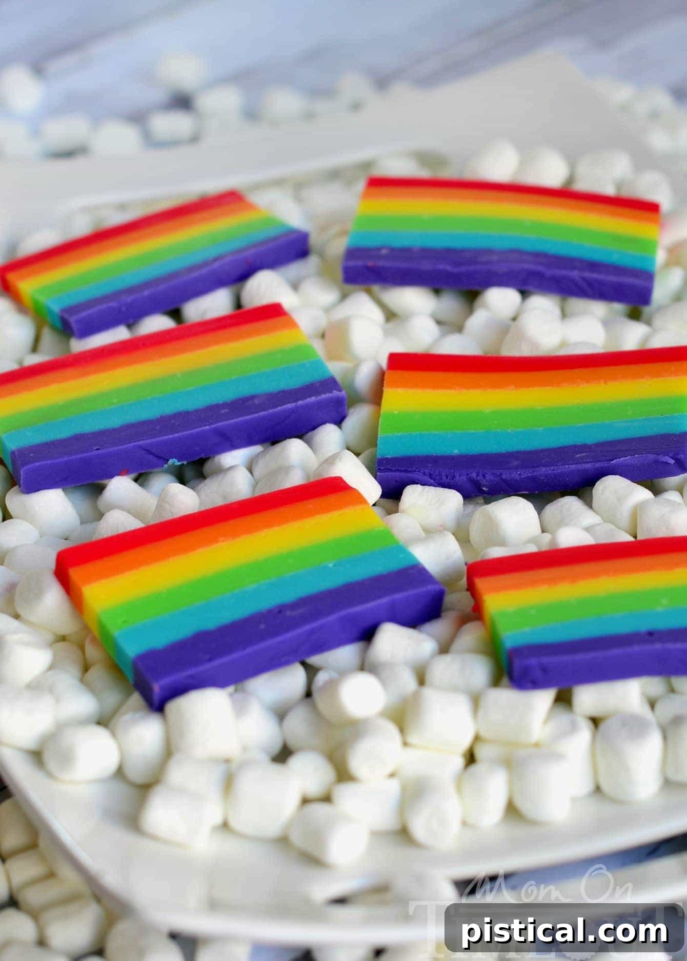 Stacked slices of Easy Rainbow Fudge, showing off the beautiful, distinct colored layers, ready for a festive celebration.