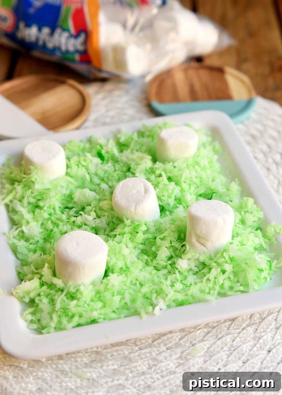Creative display idea for Reese's Easter Bunnies using green coconut grass and marshmallows