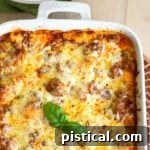Easy Lazy Day Lasagna recipe baked in white casserole dish topped with fresh basil ready to be served.