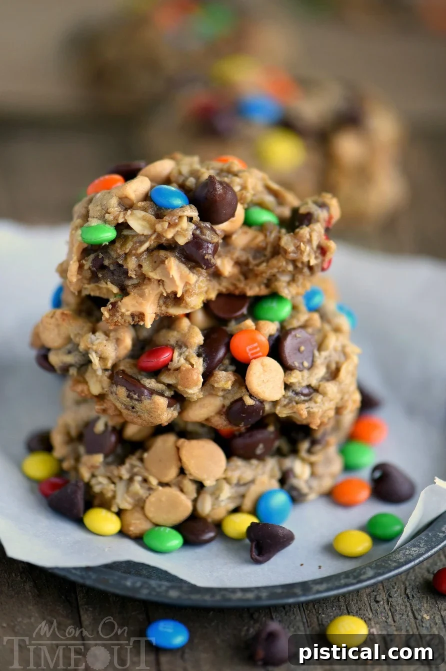 A close-up of a Monster Peanut Butter Oatmeal Cookie with a bite taken out, revealing its soft, chewy interior packed with mix-ins.
