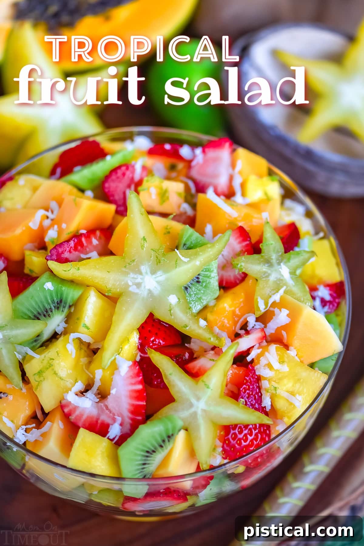Island Fruit Medley with Zesty Honey Glaze 2 fruit salad made with tropical fruits like kiwi, papaya, mango and more in a large glass bowl. title overlay at top of image.