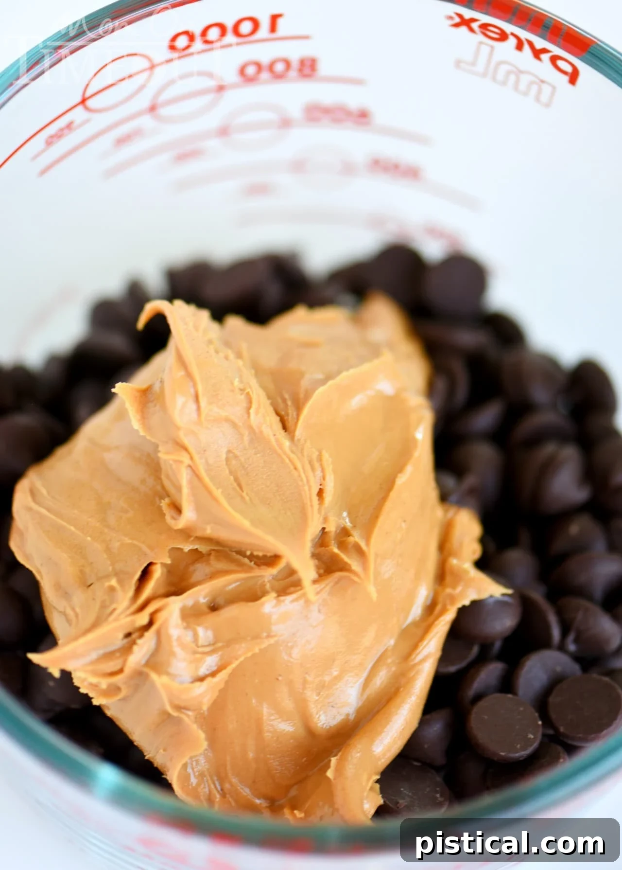 Chocolate and peanut butter melted together in a bowl for Muddy Buddies